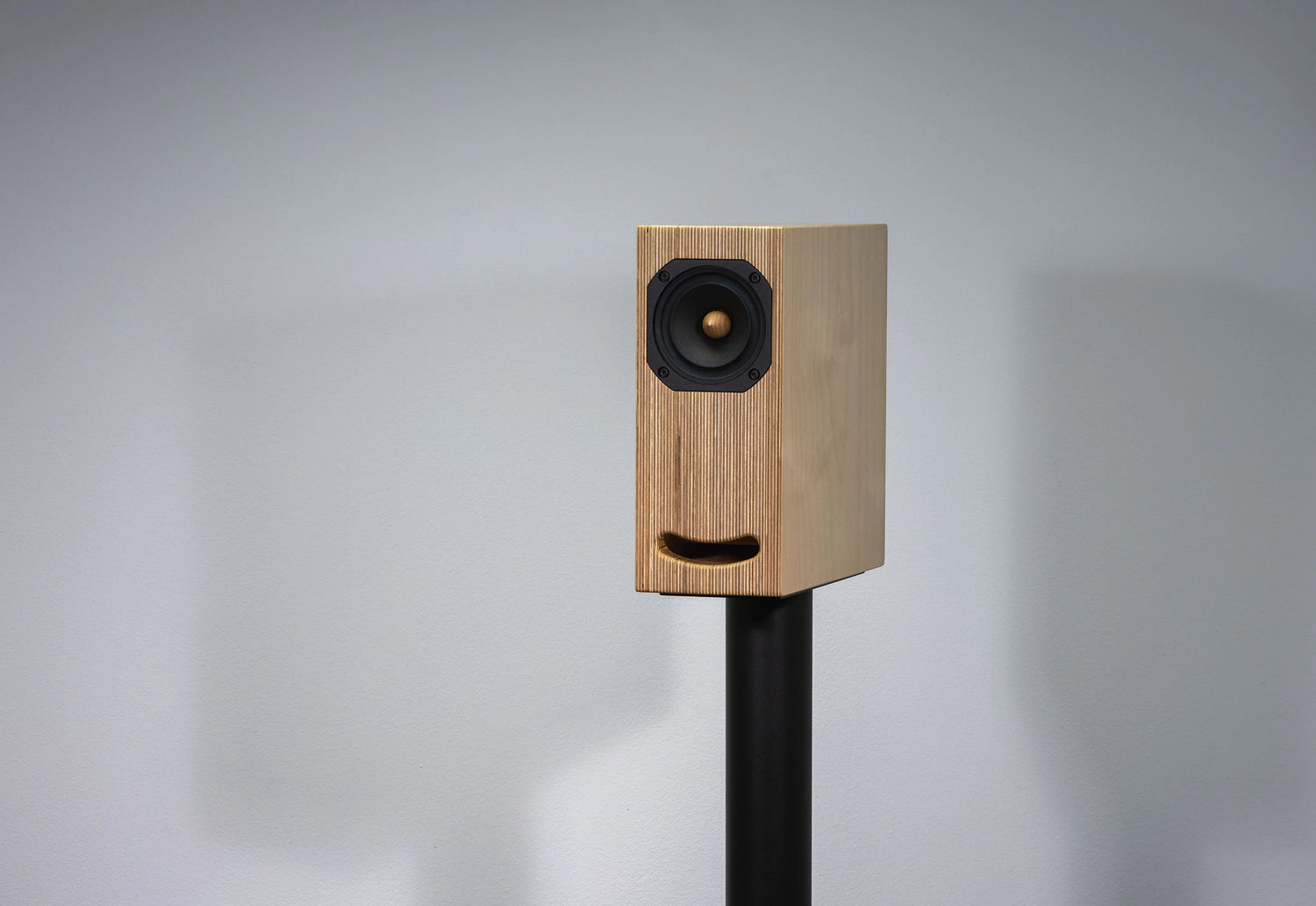 plywood loudspeaker on black stand