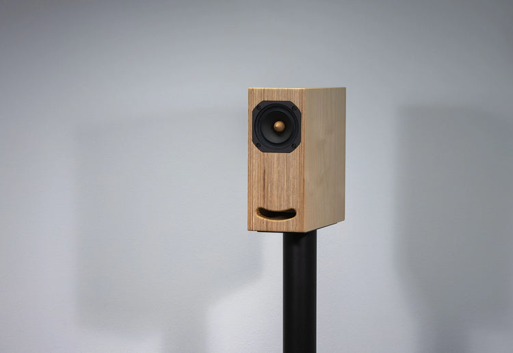 plywood loudspeaker on black stand