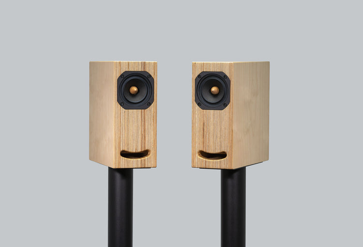 plywood loudspeaker on black stand